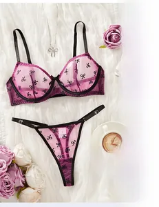 Detail of purple mesh lingerie set with black butterfly patterns and lace trim