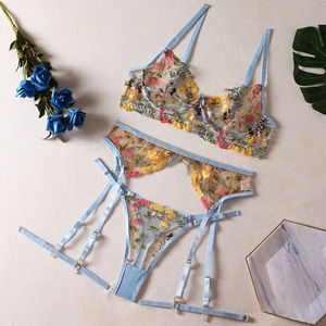 Detailed embroidery of colorful floral patterns on sheer light blue mesh lingerie set