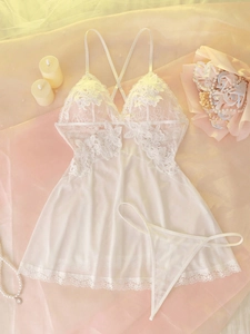 Close-up of white lace nightdress with delicate floral patterns and criss-cross straps