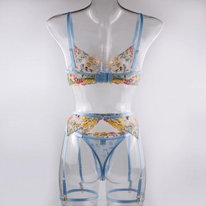 Close-up of light blue mesh lingerie with vibrant yellow floral embroidery and adjustable straps