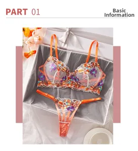 Detailed view of floral embroidery on orange mesh lingerie set in a gift box