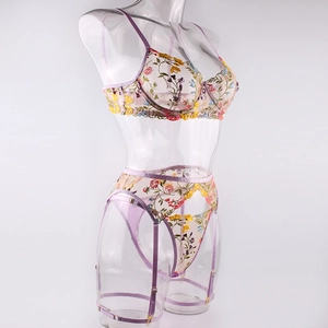 Close-up of floral embroidery on purple mesh lingerie set with adjustable straps