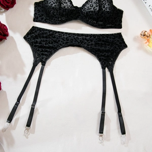 Close-up of black leopard print mesh garter belt with adjustable straps and metal clips