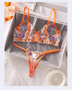 Detailed view of floral embroidery lingerie set with mesh fabric in a gift box