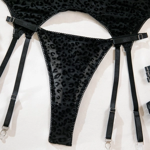 Detailed view of black leopard print garter belt set with adjustable straps and metal clips