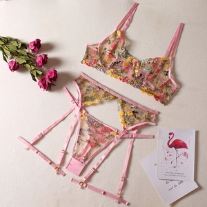 Detailed embroidery of colorful flowers on pink mesh sheer lingerie set with garter