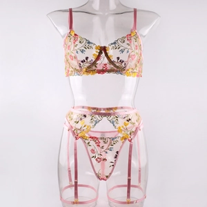 Detail view of pink floral embroidery mesh bra set with garters on transparent mannequin