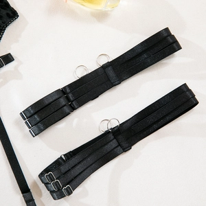 Detail of black elastic garter straps with silver metal rings and adjustable buckles