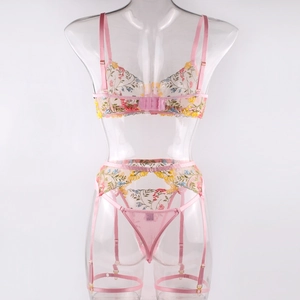 Detailed pink floral embroidery on mesh lingerie set with garter belt and adjusters