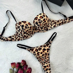 Leopard print lingerie set with underwire bra and thong on white plush background