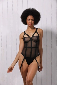 Close-up of black mesh bodysuit with cage strap design and adjustable garter straps