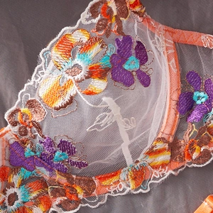 Exquisite white mesh lingerie set with vibrant floral embroidery and orange lace trim