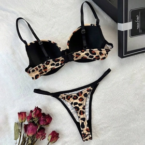 Sexy leopard print lingerie set with bra and thong on white faux fur background