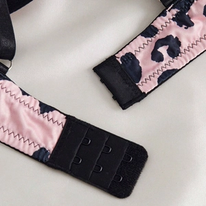 Macro detail of leopard print lingerie set featuring adjustable three-row back hook closure