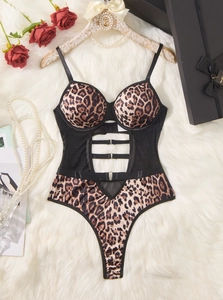 Detail of leopard print bodysuit featuring waist cut-outs and black mesh side panels