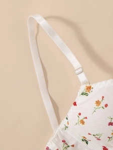 Detail of white ribbed cotton floral bra set with delicate lace trim and adjustable strap