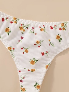 Detail of white ribbed fabric panties with floral print and scalloped lace trim