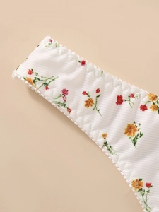 Close-up of white floral ribbed bra strap with delicate lace trim and sweet flower pattern