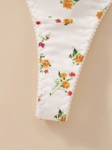 Detailed macro view of white ribbed fabric with floral print and delicate lace trim