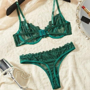 Dark green eyelash lace lingerie set with underwire bra and thong on beige faux fur
