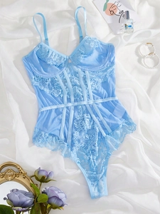 Close-up of floral lace texture and ribbon detailing on this light blue teddy bodysuit