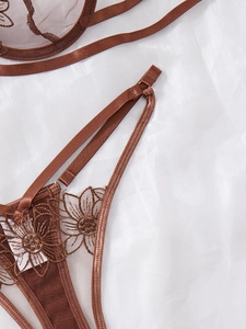 Detail of coffee brown embroidery lace lingerie set with fine mesh and floral patterns