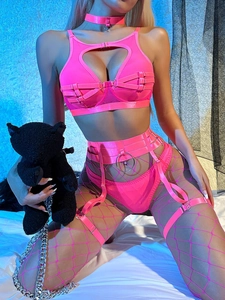 Detail of neon pink fishnet lingerie set featuring heart cutouts and metallic ring accents