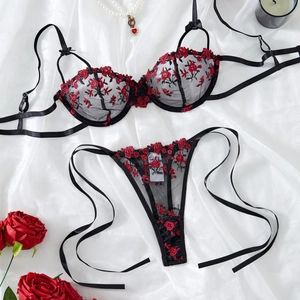Sexy black lace lingerie set with red rose embroidery on elegant white silk background