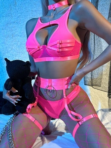 Detail of neon pink fishnet lingerie set with heart cutouts and strappy metallic ring accents