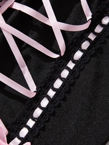 Detailed view of pink satin lacing and delicate black lace on a sexy bodysuit