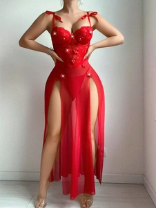Detail of red sheer evening gown featuring floral lace bodice and high side slit