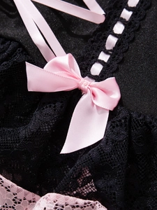 Detail of sexy black lace bodysuit with pink satin ribbons and a delicate bow tie