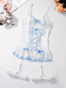Flat lay of white lace bodysuit with light blue bow details and adjustable straps