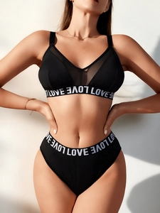 Close-up of black mesh V-neck bra set featuring LOVE lettered elastic band details