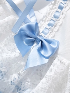 Detailed macro shot of white lace lingerie with a bright light blue satin ribbon bow decoration
