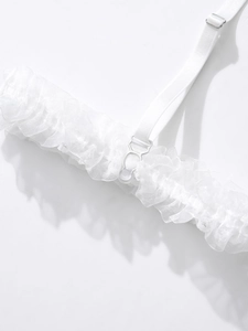 Detail of white lace garter strap with adjustable silver metal buckle and soft shadow
