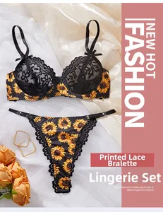Detail view of sunflower print and black lace bra set with satin background