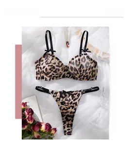 Detailed view of leopard print lace bra set with satin texture and black bow accents