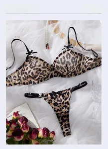 Flat lay of leopard print lace bra set with thong and romantic decorative accents