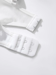 Close-up of white lace bodysuit back closure featuring double-row three-hook fastening