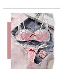 Detailed view of a pink plaid lingerie set with white lace trim and red bow accents