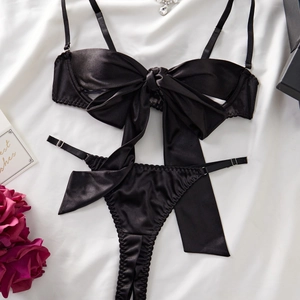 Sexy black satin lingerie set with large bow bra and thong on white background