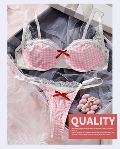Detailed flat lay of pink gingham lingerie set with delicate lace and red bows