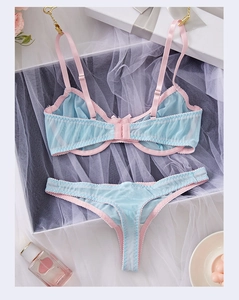Detailed flat lay of blue mesh lingerie set with pink trim and delicate lace texture