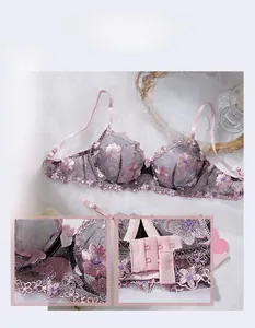 Detail of floral lace embroidery and three-row hook closure on pink and black lingerie set