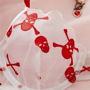 White sheer lace lingerie set featuring red skull embroidery and wavy scalloped edges