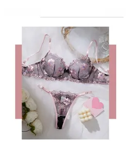 Detail of lavender lace lingerie with floral embroidery and sequins on white mesh