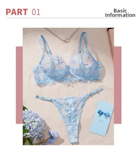Flat lay of baby blue lace lingerie set with floral embroidery and elegant pearl accents