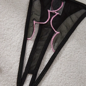 Sexy black mesh lingerie set with pink body outline embroidery on soft plush background