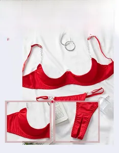 Detail of red satin lingerie set with metal chain straps and matching thong